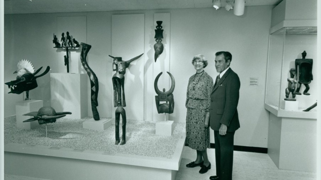 man and woman in an art gallery surrounded by African art objects