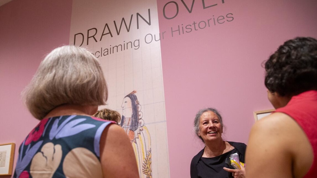 “Drawn Over” guest curator Jacki Thompson Rand smiles Aug. 24 as she talks with people about this newest exhibition at the Stanley Museum of Art in Iowa City. The exhibition runs through Jan. 2. The group shows the art and history the Indigenous Plains men who drew on pages ripped from government ledger books and given to them after they no longer had enough buffalo hides. (Savannah Blake/The Gazette)