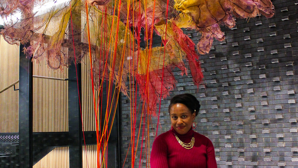 Nnenna Okore posing with her artwork "Spirit Dance"
