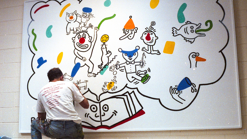 Keith Haring at work on the mural at Ernest Horn Elementary School