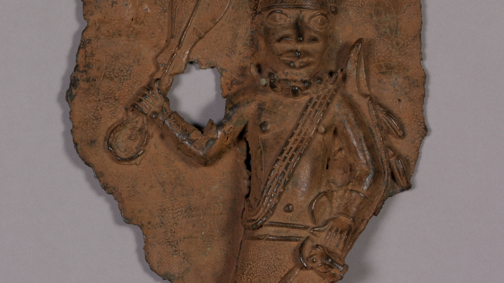 A bronze plaque depicting a figure