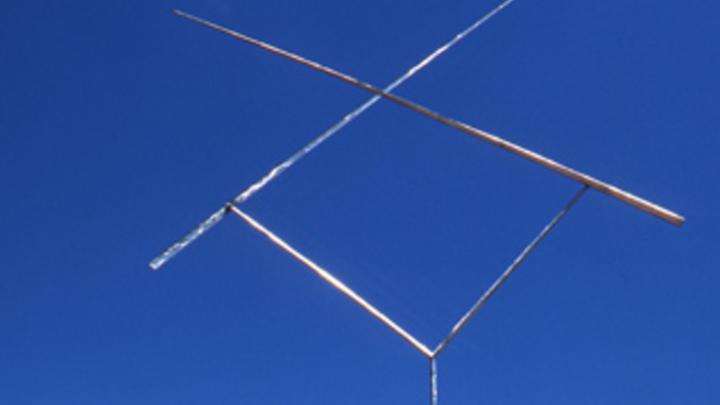 A tall skinny “Y” shaped piece of steel with two metal rods attached to each point that intersect with each other maxing the shape of an “X”.