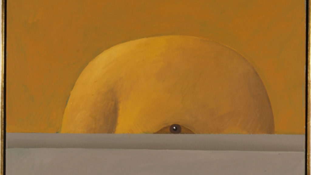 The top of a bald head peeks over a grey wall, with the eye half visible. The head and background are a similar color of orange, which makes the head appear camouflaged.