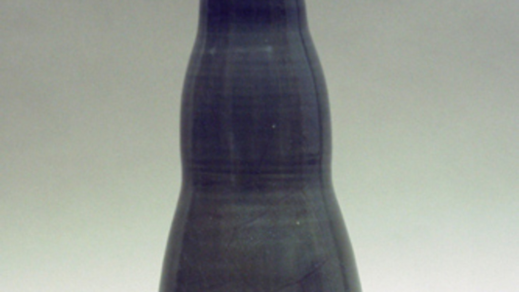 Shiny black vase that is narrower at the top than bottom, and has curves that create three rounded sections.